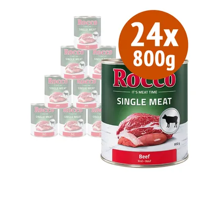Rocco Single Meat Beef, confezione da 24 lattine da 800 g ciascuna. Testo visibile: 'Rocco', 'It's meat time', 'Single Meat', 'Beef', immagine di carne e icona cane. Rocco Single Meat Beef, confezione da 24 lattine da 800 g ciascuna. Testo visibile: 'Rocco', 'It's meat time', 'Single Meat', 'Beef', immagine di carne e icona cane.