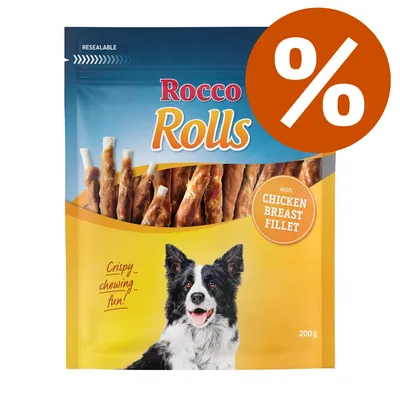 Rocco Rolls, snack per cani con bastoncini avvolti in filetto di petto di pollo, confezione da 200 g. Testo visibile: 'Crispy chewing fun!', 'with chicken breast fillet'. Simbolo percentuale.