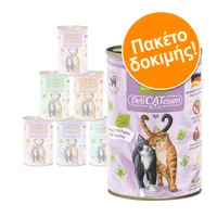 Πακέτο δοκιμής DeliCATessen. Κονσέρβες με εικόνα δύο γατών, ορατά συστατικά αρνί & γαλοπούλα, σήμα χωρίς δημητριακά, σημαία Γερμανίας, κείμενο 'Paté' και 'Lamm & Truthahn'.