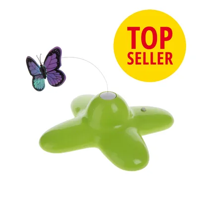 Vihreä muovinen leikkilaite, jossa on langassa liikkuva violetti-perhonen. Keltainen ympyrä, jossa punaisella teksti TOP SELLER.