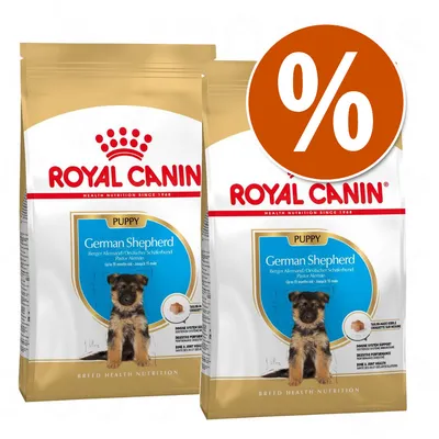 Dos sacos de pienso Royal Canin Puppy German Shepherd con imagen de cachorro y texto promocional de porcentaje en círculo naranja.