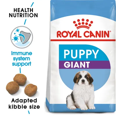 Royal Canin Puppy Giant -koiranruokapakkaus, tekstit: Health Nutrition, Immune system support, Adapted kibble size. Kuvassa myös nappuloita ja pentukoira. Royal Canin Puppy Giant -koiranruokapakkaus, tekstit: Health Nutrition, Immune system support, Adapted kibble size. Kuvassa myös nappuloita ja pentukoira.