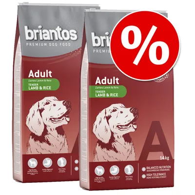 Dve vreči hrane za pse briantos Adult Tender Lamb & Rice, 14 kg, z rdečim krogom in simbolom %. Vidna angleška besedila: High Quality Animal Proteins, Easily Digested, Very Tasty, Balanced Nutrition. Dve vreči hrane za pse briantos Adult Tender Lamb & Rice, 14 kg, z rdečim krogom in simbolom %. Vidna angleška besedila: High Quality Animal Proteins, Easily Digested, Very Tasty, Balanced Nutrition.