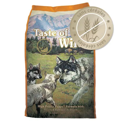Sac Taste of the Wild High Prairie Puppy Formula with Roasted Venison & Bison, texte visible : sans céréales. Illustration de loups sur l’emballage.