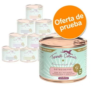 Latas de comida para perros Terra Canis, texto visible: 'GETREIDEFREI', 'Huhn mit Pastinaken, Brombeeren & Löwenzahn', 'LAKTOSEFREI'. Sello naranja: 'Oferta de prueba'.