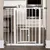 White metal safety barrier with small door, suitable for doors or stair areas. Screw mounting visible on both sides.