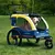 Yellow and blue dog trailer with 'Hafenbande' inscription, three wheels, mesh window and handle. Suitable for transporting pets.