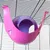 Pink and purple plastic hanging hideout attached to metal cage bars, spherical shape with open entrance visible.
