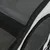 Close-up of black mesh material with zip, part of a transport bag or box.