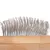 Close-up of a brush with fine metal bristles and a wooden handle.