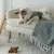 Hund auf Sofa betrachtet ein braunes Plüschspielzeug in Bärenform auf dem Teppich. Hund auf Sofa betrachtet ein braunes Plüschspielzeug in Bärenform auf dem Teppich.