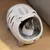 Cat-shaped cat cave made of plastic with ventilation slots, a cat is lying inside on a cushion.