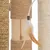 Cat tree elements made of wood and sisal with beige feather pendant. Close-up view of materials.