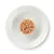 Portion de pâtée ou nourriture humide pour animaux, présentée en boule sur une assiette blanche vue du dessus. Aucun emballage ni marque visible.