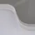 Close-up of a white plastic edge with a curved shape, possibly part of a product.