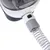 Close-up view of a white and grey device with a transparent tube and green push button. Functional elements visible.