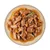 Close-up of juicy meat pieces in sauce with carrots and a sprig of rosemary on a plate.
