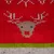 Rotes Strickmuster mit Rentiermotiv, grüner und grauer Streifen am unteren Rand.