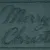 Text 'Merry Christmas' in cursive script on a textured surface.