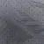 Close-up of grey fabric with small black dots, possibly material description for a product.