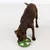 Brown dog eating from a green anti-gulp bowl with a white base and obstacles for slow feeding.