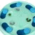 Round green feeding toy with blue paw covers and compartments, filled with dry food pieces. Encourages slow eating through interactive use.