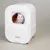 kooa. White automatic pet care device with wooden legs and controls on the side.