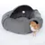 Grey cat bed with cave shape, soft inner cushion and toy ball. Cat exits the bed through a side entrance.