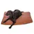 Coussin rectangulaire marron en tissu, un grand chien noir allongé dessus. Étiquette visible sur le coin du coussin.