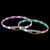 Deux colliers lumineux en plastique avec LED multicolores, boutons marche/arrêt visibles sur chaque collier. Lumières vertes, rouges, violettes et blanches réparties autour des colliers. Deux colliers lumineux en plastique avec LED multicolores, boutons marche/arrêt visibles sur chaque collier. Lumières vertes, rouges, violettes et blanches réparties autour des colliers.