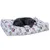 Chien noir allongé sur un grand coussin rectangulaire à motifs colorés (valises, trains, lettres, logos Platform 9 3/4) sur fond blanc.