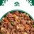 Close-up of wet food with meat pieces, carrots, peas and potatoes in a green bowl. Logo with tree and animals visible at the top.