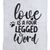 Teksti harmaalla kankaalla: 'Love is a four legged word' tassunjäljellä ja sydänsymbolilla.