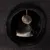 Cat inside a round, dark fabric hideaway with a hanging plush ball toy at the entrance, demonstrating use of the enclosed pet furniture.