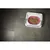 Automatic feeder with a pink bowl containing wet food, shown from above with the lid partially closed to demonstrate food storage or portion control.