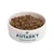 Bowl filled with brown dry food pieces, labelled 'Autarky Complete Dog Food' on the front of the bowl.
