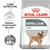 Royal Canin Dental Care Mini. Reduce la formación de sarro. Resultados probados: reducción de la formación de sarro hasta el 69 %. Imagen de un perro pequeño en el envase.