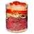 Glass container with visible layers of raw beef chunks, spiralised courgette, sliced carrot, shredded cabbage, and diced tomato on top of yellow grains. No brand or text visible.