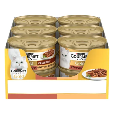 Six cans of Gourmet Gold wet food in a tray, visible flavours include casserole with beef and turkey in brown sauce and with duck. Product labels and serving suggestion shown.