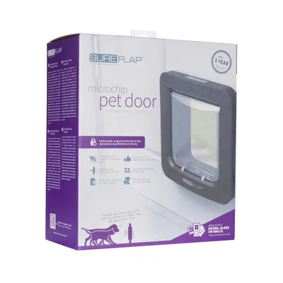 SureFlap microchip pet door packaging showing features: curfew mode, stores up to 32 microchip IDs, battery powered, suitable for doors, glass or walls, three-year guarantee.