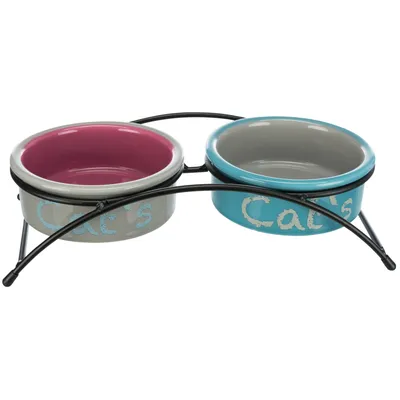 Doppelnapf-set met metalen standaard, twee keramische kommen: één grijs-roze, één grijs-blauw, beide met opschrift 'Cat's'.