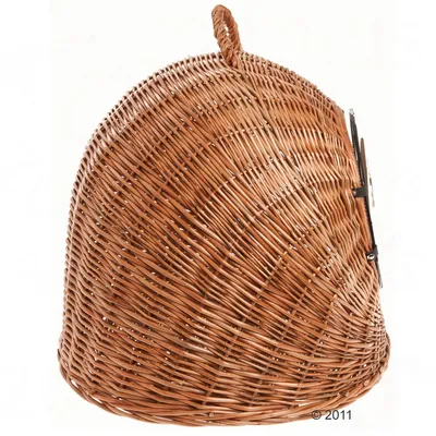 Wicker pet carrier with a rounded shape, top handle and metal latch on the side for secure closure.
