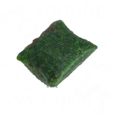 En enkelt grøn pudeformet foder- eller godbidspille, uden synlig emballage eller mærkning. Materiale og indhold ikke angivet.