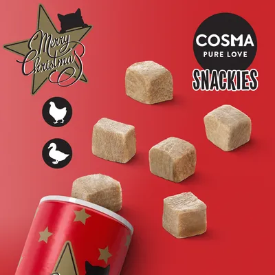 Cosma Pure Love Snackies, cubos de snack liofilizado, embalagem vermelha com estrelas. Ícones de frango e pato visíveis. Texto: Merry Christmas.