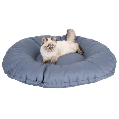 Rond, gewatteerd ligoppervlak in blauw met een kat erop. Product voor ontspanning of slaap voor huisdieren.