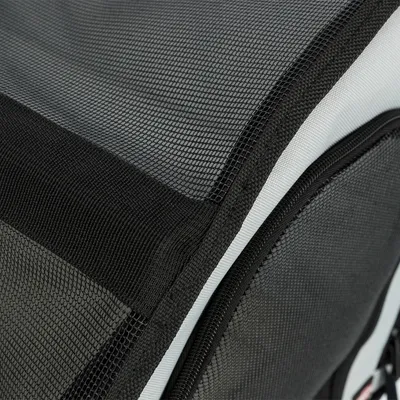 Close-up of black mesh material with zip, part of a transport bag or box.