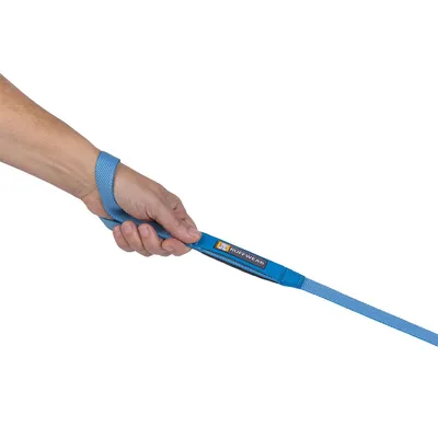 Hand holding blue Ruffwear lead with visible padded handle and Ruffwear brand label