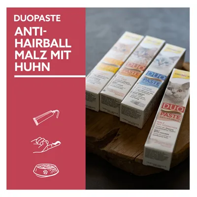 Duopaste Anti-Hairball Malz mit Huhn. Produktabbildung von mehreren Tuben auf Holzunterlage, geeignet zur Fütterung und Handanwendung.