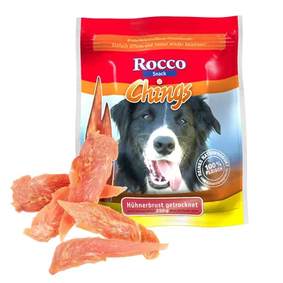 Rocco Snack Chings, Hühnerbrust getrocknet 250 g, sachet avec morceaux de blanc de poulet séché visibles. Texte en allemand et anglais sur l’emballage.