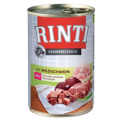 RINTI Kennerfleisch dåse med teksten 'MIT WILDSCHWEIN', 'NEU noch mehr natürliche Fleischstücke' og billede af kødtern, lever og skinke på træbord.